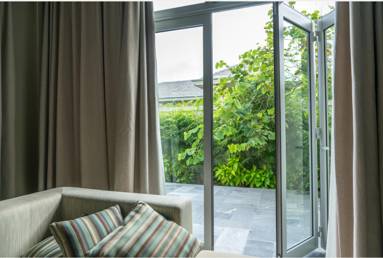 An open window removes indoor air pollution, particularly in a garden surrounded by lots of trees and vegetation.